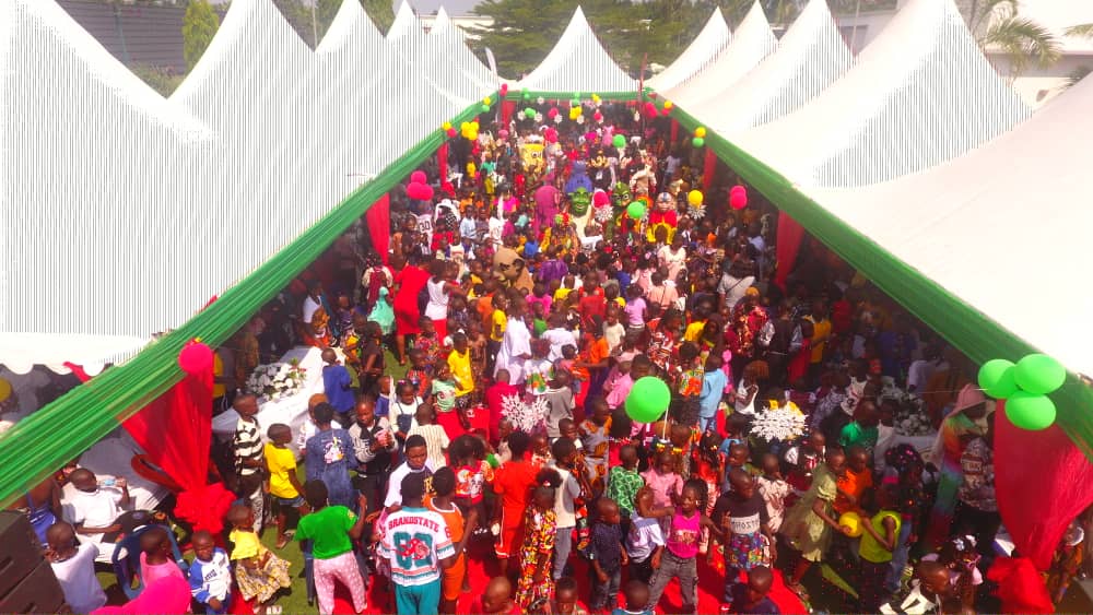 Aerial view — hundreds of children under the event marquee